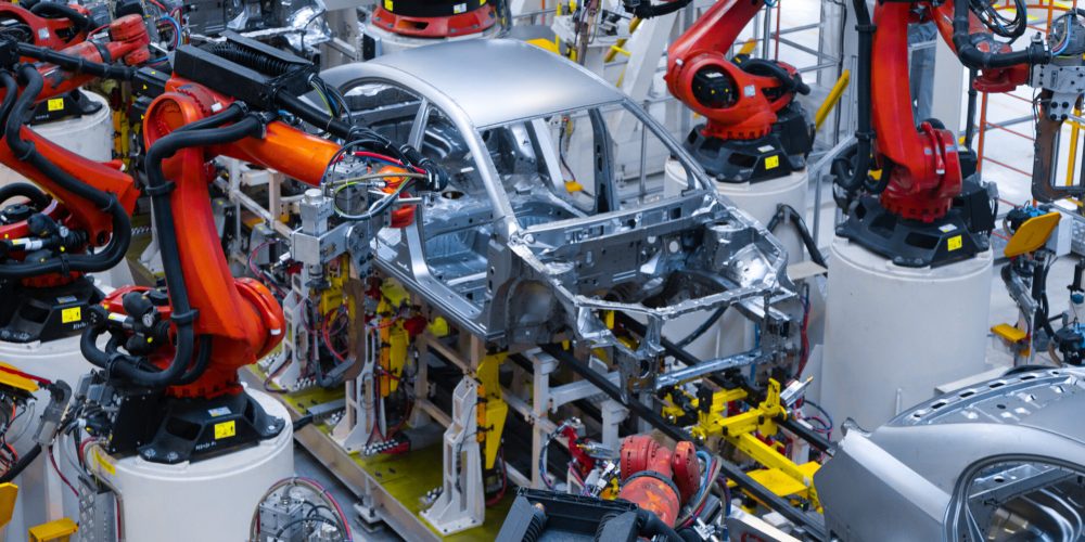 Assembly line production of new car. Automated welding of car body on production line. robotic arm on car production line is working